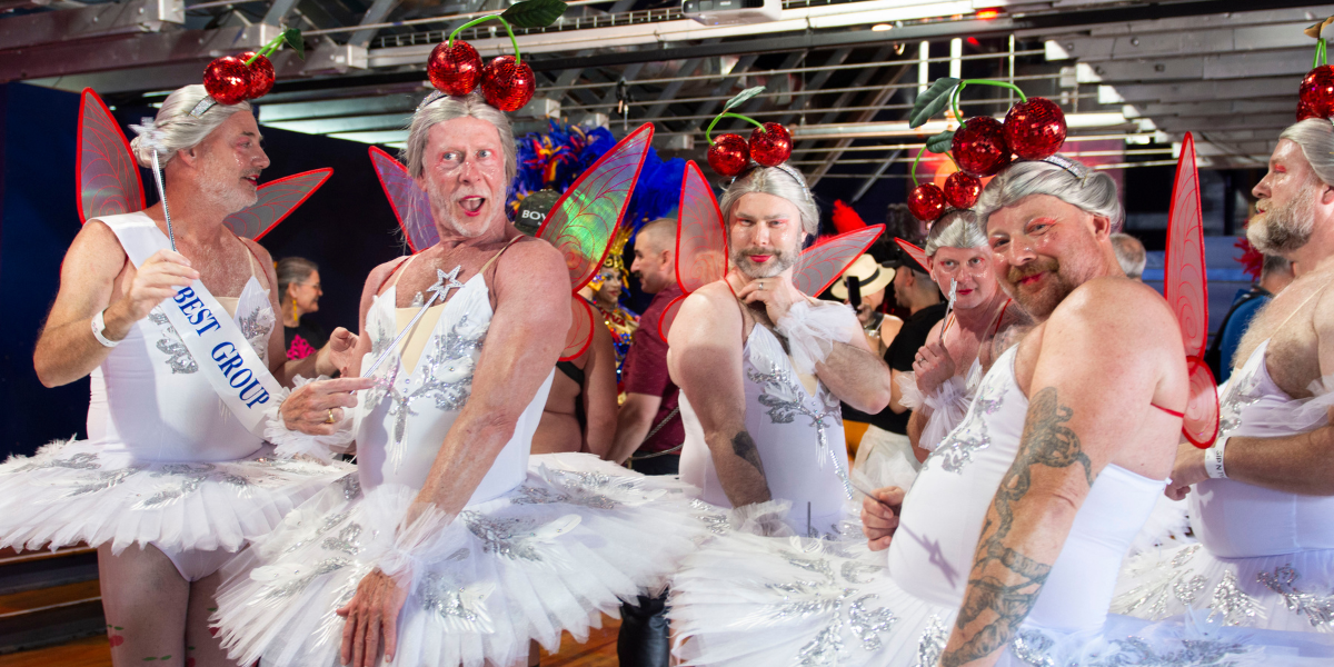 a group of attendees of the 50th invasion of the pines in drag with white tutus and cherry headpieces