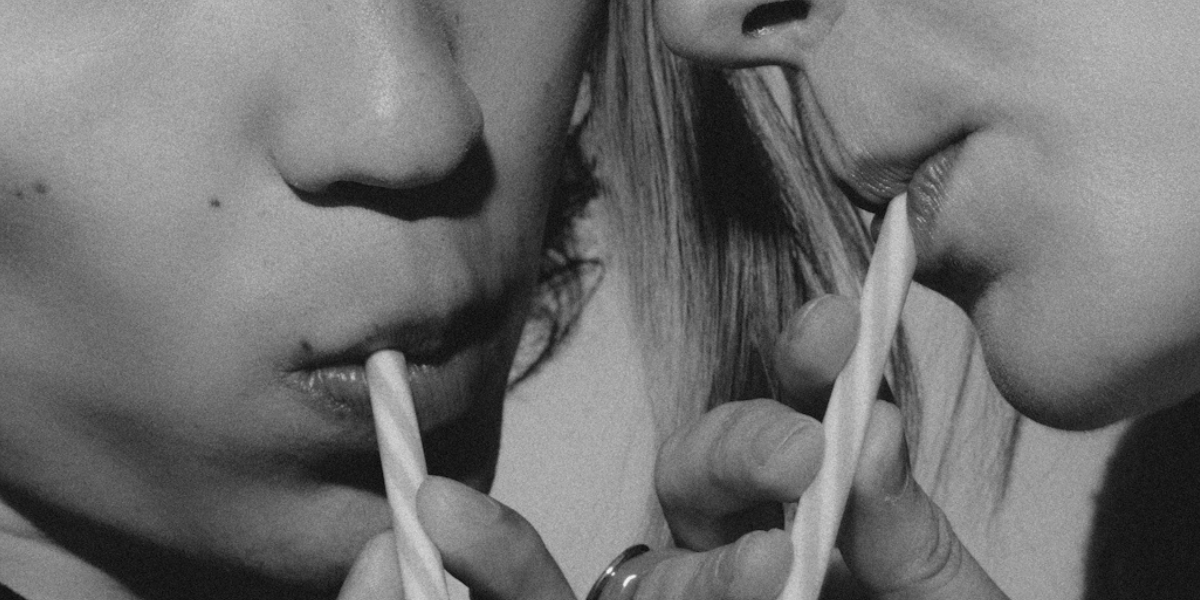 two people sipping milkshakes