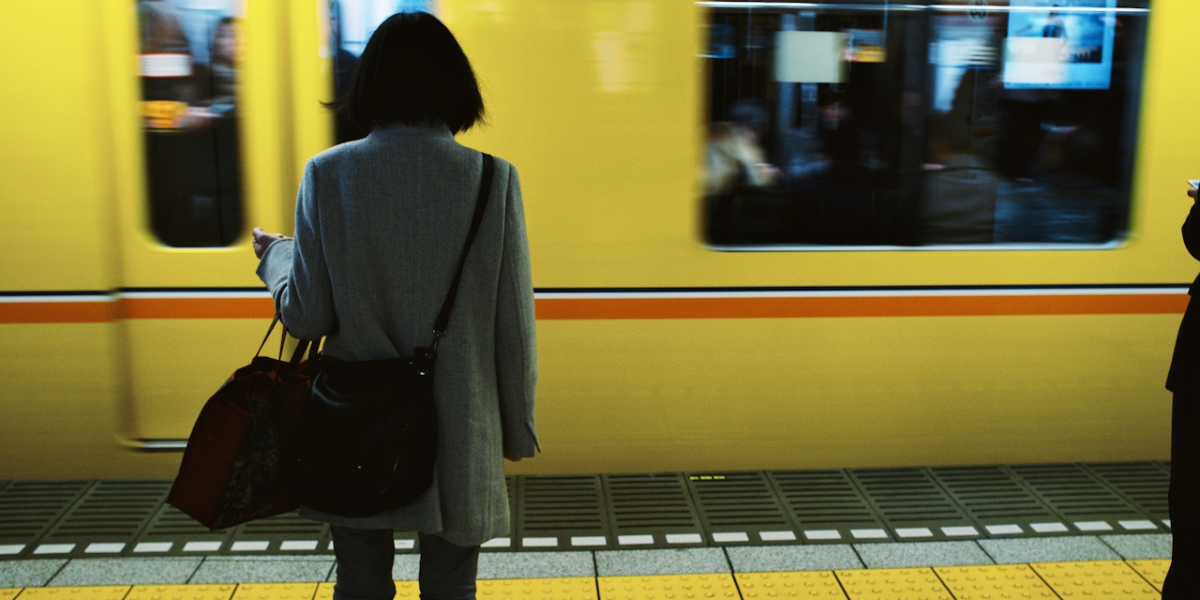 a person waiting alone for a train