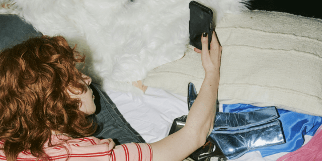 a person in bed with a phone