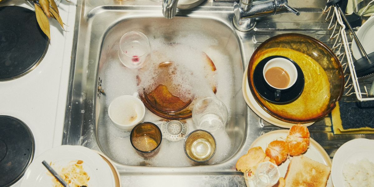 a messy sink with dirty dishes