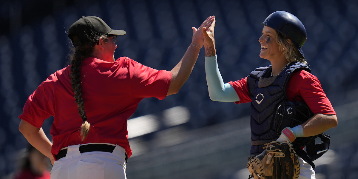 WASHINGTON, DC - AUGUST 25: Kylie Lahners and Denae Benites high five in a scrimmage during tryouts for the Women’s Professional Baseball League at Nationals Park on August 25, 2025 in Washington, DC. The tryouts are the first women’s professional baseball tryouts to be held in over 80 years since the All American Girls Professional Baseball League in 1943. The Women’s Professional Baseball League will launch six teams in the spring of 2026 and feature a regular-season playoffs and championship. (Photo by Jess Rapfogel/Getty Images)
