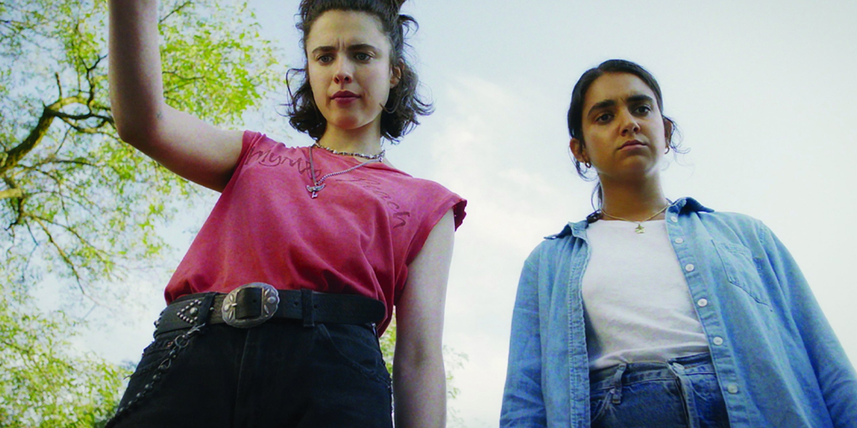 the main characters in Drive Away Dolls wearing belts