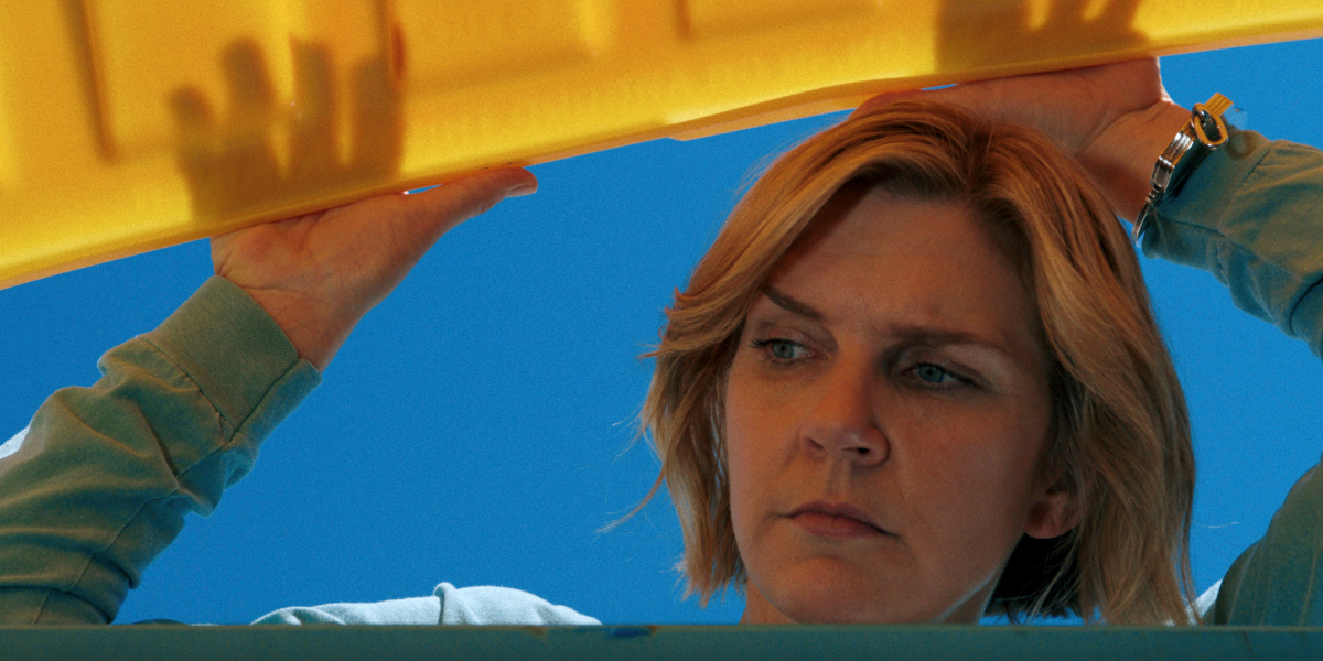 Carol looking in a dumpster