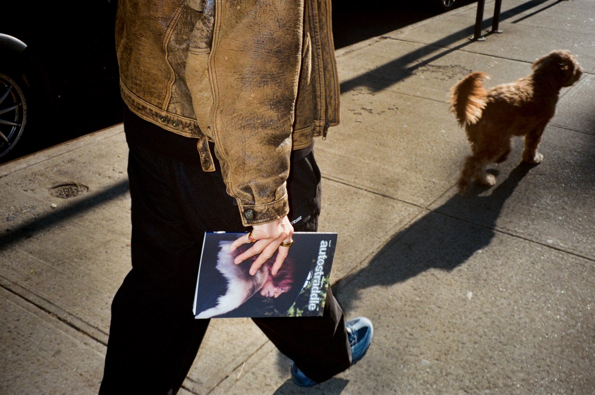 a person carrying the Autostraddle print magazine