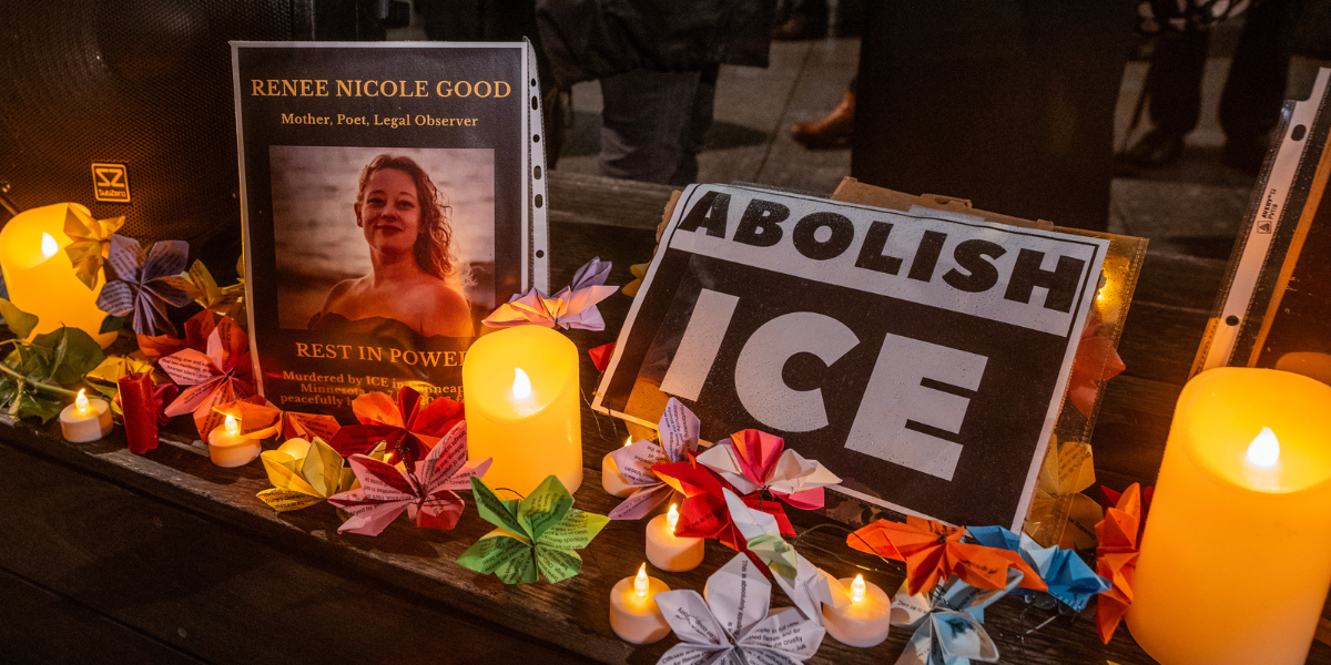 Renee Nicole Good vigil and a sign that says ABOLISH ICE