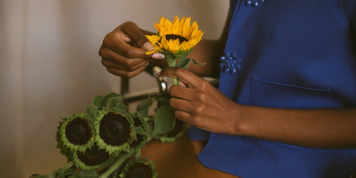 a hand picking petals