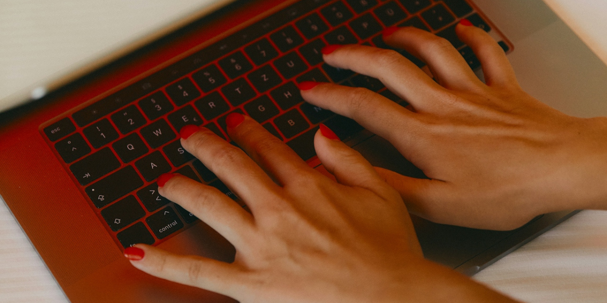 a person typing on a computer - how to avoid getting catfished