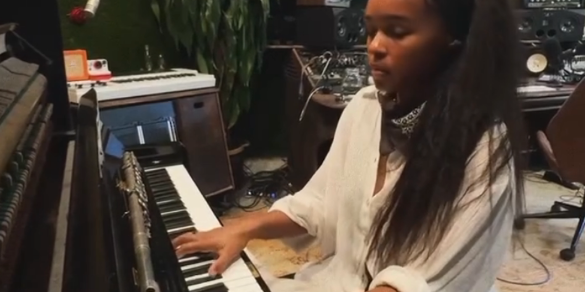 Janelle Monae at a piano
