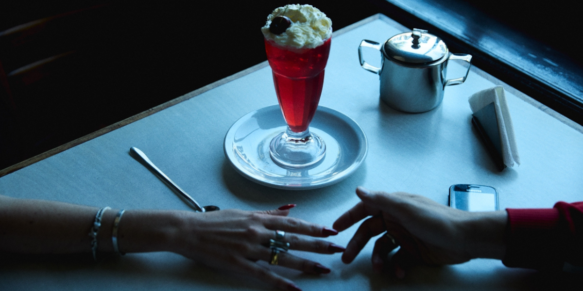 hands reaching across a diner table