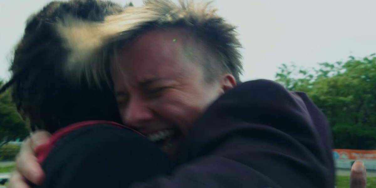 two people embracing in the queer friendship film Sinner Supper Club