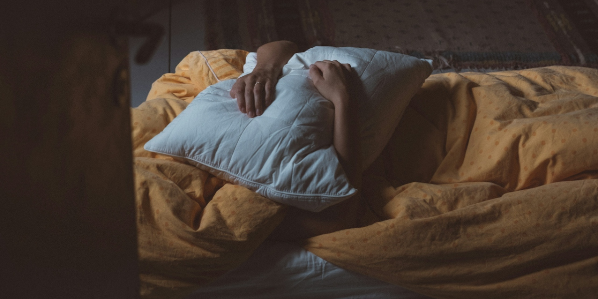 a person hugging a pillow