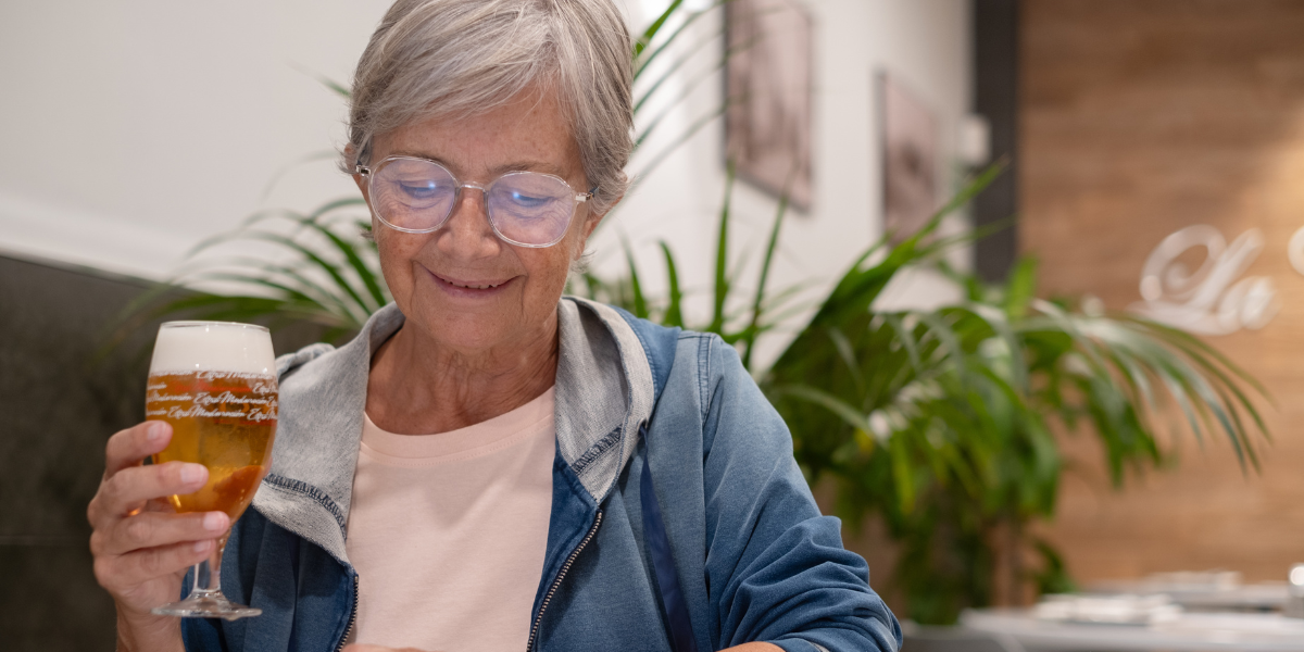 a grandma holding a beer