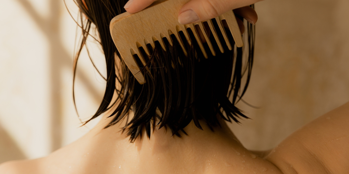 a hand with a comb on hair