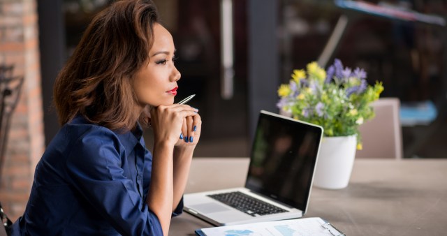 woman (over)thinking at a desk